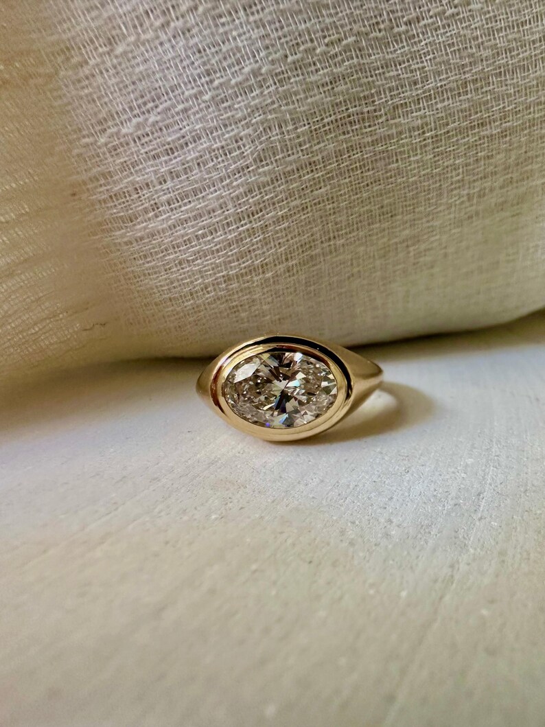18K Oval Lab Diamond Ring, in a Signet Ring style featuring a bezel set 2ct Oval Lab Diamond | Ella Creations Jewelry