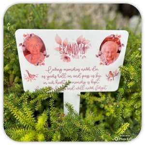 May include: A white wooden memorial sign with pink floral accents and two photos of an older woman. The sign reads "GRANDMA Loving memories never die as years roll on and pass us by in our hearts memory is kept and will never forget."