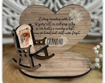 May include: Wooden heart-shaped plaque with a rocking chair and a photo of a person. The plaque has a wood grain texture and the text "Loving memories never die as years roll on and pass us by. In our hearts a memory is kept. Ones we loved and will never forget GRANDAD".