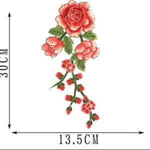 May include: A red embroidered floral applique with three large roses and smaller flowers on a green stem. The applique measures 13.5 inches wide and 30 inches tall.