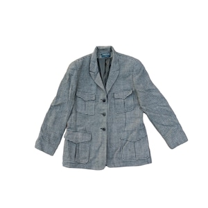 May include: A black and white checked blazer with four pockets and a button closure.