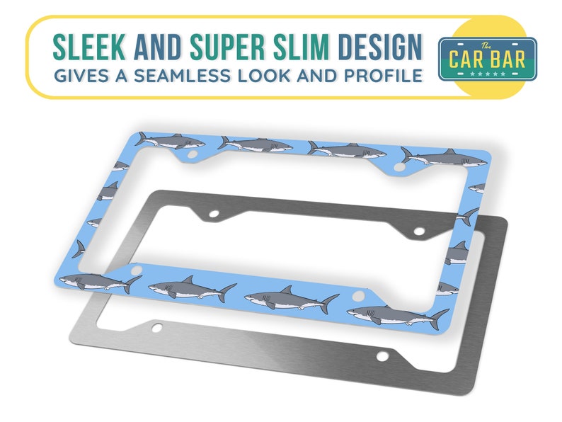 May include: A blue and silver license plate frame with a shark pattern. The frame is made of metal and has a sleek and slim design. The text "The Car Bar" is printed on the frame.