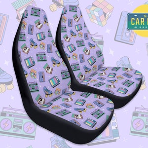 May include: Two purple car seat covers with a retro 80s pattern featuring roller skates, cassette tapes, boomboxes, and televisions. The text "The Car Bar" is visible in the background.