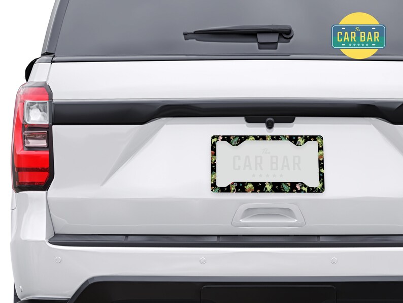 May include: A black license plate frame with a green and white floral pattern and the text "The Car Bar" in white.