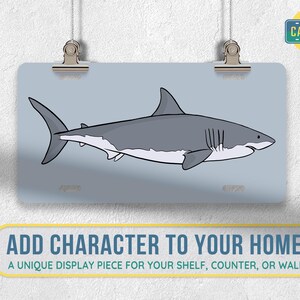 May include: A white great white shark with a gray back and a white belly is swimming to the right. The shark is on a light blue background. The image is a unique display piece for your shelf, counter, or wall.