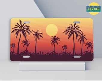May include: A sunset scene with palm trees silhouetted against a gradient background of orange, red, and yellow. The sun is a large yellow circle in the sky. The text "The CAR BAR" is in a blue rectangle at the top of the image.