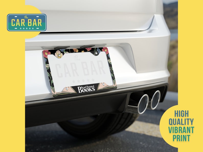May include: A black and white license plate frame with a floral design and the text "The Car Bar" and "Read Beyond Books".