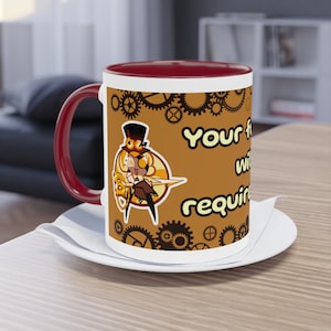 May include: A white ceramic mug with a red rim and handle. The mug features a cartoon character with gears and the text "Your first win will require..." in yellow.