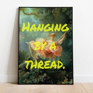 Puede incluir: Una pintura vintage de una mujer en un columpio en un entorno boscoso. La pintura está enmarcada en negro y tiene el texto "HANGING BY A THREAD." escrito en amarillo sobre la imagen.