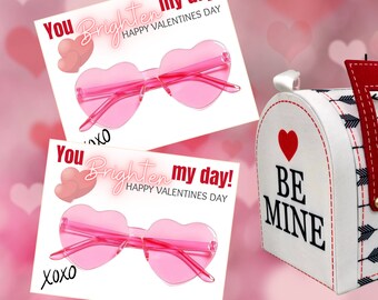 May include: Two printable Valentine's Day cards featuring pink heart-shaped sunglasses and the text "You brighten my day! Happy Valentine's Day" with "xoxo" written below.