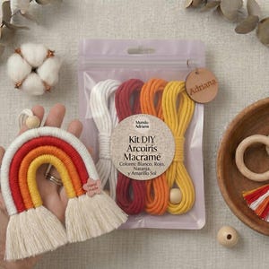 Può includere: Un arcobaleno in macramè fatto a mano in rosso, arancione e giallo, tenuto in mano. Un kit con cordoncini di macramè bianchi, rossi, arancioni e gialli è in un sacchetto trasparente. Una ciotola di legno contiene un anello di legno, una pietra e un nappa.