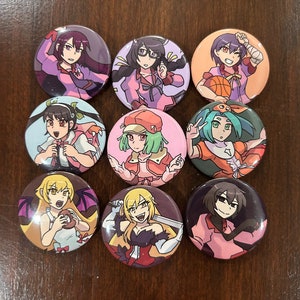 May include: Nine round buttons featuring anime characters with different expressions and poses. The characters are wearing various outfits, including a pink dress, a red and white dress, a blue and white dress, a green and white dress, a yellow and black dress, a purple and white dress, a red and white dress, a blue and white dress, and a pink and white dress.