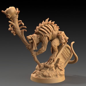 May include: A brown, skeletal rat-like creature with a staff topped with a skull, standing on a base with a tombstone that reads "Beneath this stone rests the spirit of the great rat Nipnock".