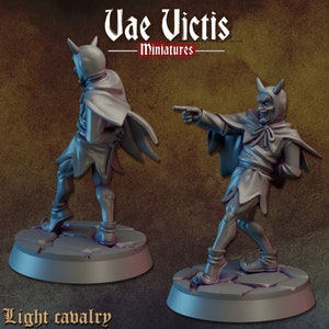 May include: A gray miniature figure of a devil-like character in a cloak, pointing. The figure has horns and is standing on a circular base. The text "Vae Victis Miniatures" is at the top, and "Light cavalry" is at the bottom.