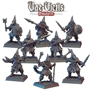May include: Set of seven miniature figures, each wearing a hooded robe and holding a weapon. The figures are painted in shades of gray and are standing on small bases. The figures are part of a tabletop game or role-playing game.