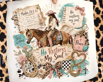 May include: A white decorative pillow featuring a cowgirl riding a horse with angel wings. The design includes text from Psalm 23:3, the phrase "He Restores My Soul," and decorative elements like horseshoes, crosses, and floral accents.