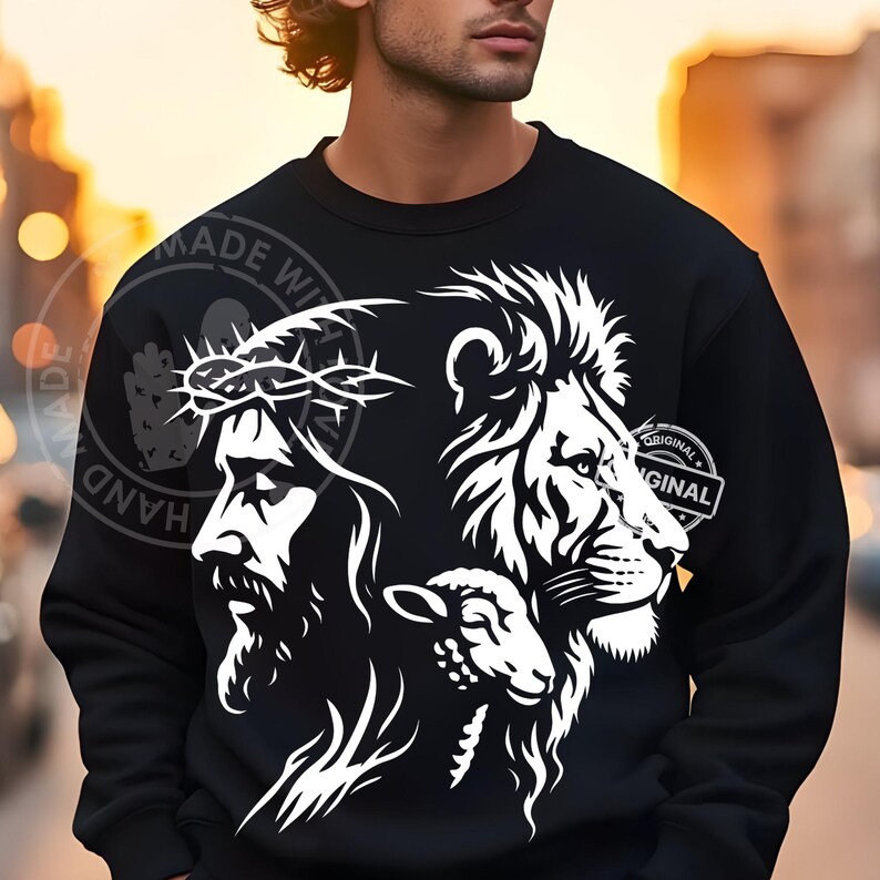 May include: Black sweatshirt featuring a white graphic of Jesus wearing a crown of thorns, a lion, and a lamb. The design includes the words "ORIGINAL" and "HAND MADE WITH LOVE".