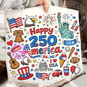 May include: A white square towel with a colorful illustration celebrating America's 250th anniversary. The design includes the American flag, the Statue of Liberty, fireworks, and the text "Happy 250 America".