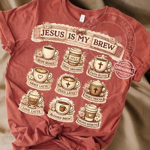May include: Red t-shirt with the text "JESUS IS MY BREW" and coffee-themed graphics. The graphics include various coffee cups and phrases like "Hope Roast," "Grace Latte," and "Faith Blend." A small "Original" sticker is visible.