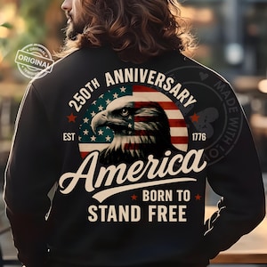 May include: Black sweatshirt featuring a patriotic design for the 250th anniversary of America. The design includes an American flag, an eagle, and the words "America Born to Stand Free."