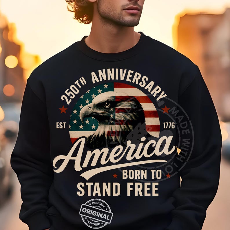 May include: Black sweatshirt with a graphic featuring an eagle, the American flag, and the text "250th Anniversary America Born to Stand Free." The design includes the year 1776 and the word "Original."