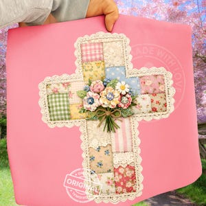 May include: A pink cross-shaped decoration with a patchwork design. The cross features squares of floral and patterned fabrics, a white lace border, and a bouquet of flowers. The words "MADE WITH LOVE" and "ORIGINAL" are visible.