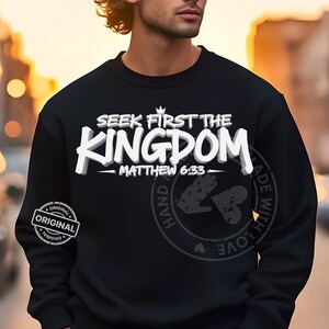May include: Black sweatshirt with the text "SEEK FIRST THE KINGDOM" in white, with "MATTHEW 6:33" below. A circular graphic on the right side reads "HAND MADE WITH LOVE". An "ORIGINAL" stamp is on the left sleeve.
