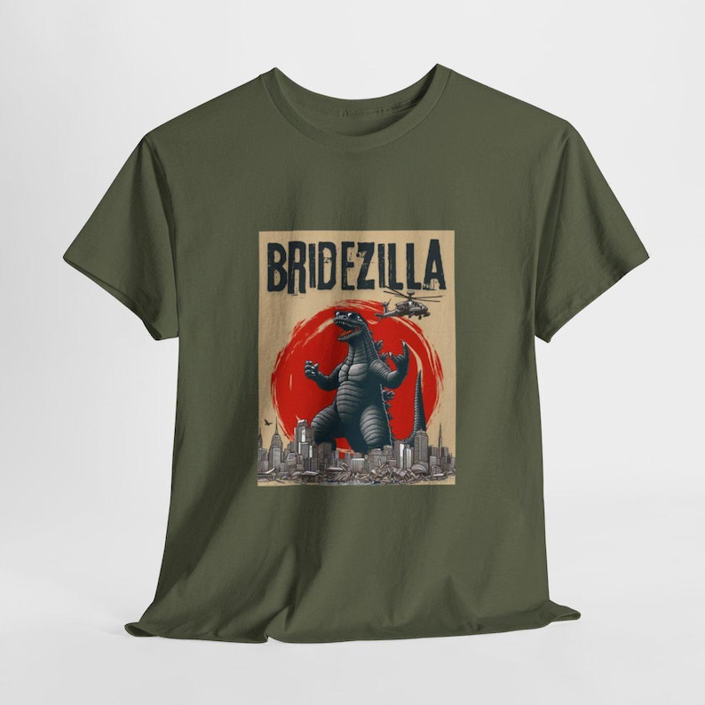 May include: A green t-shirt with a graphic print of a Godzilla-like monster in front of a cityscape. The text "Bridezilla" is printed above the monster.