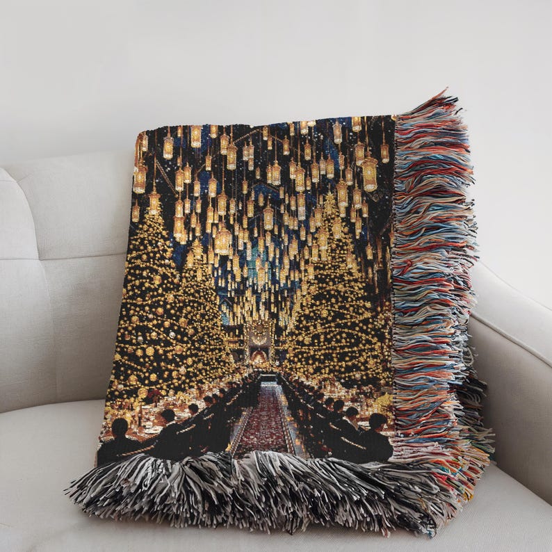 May include: A woven throw blanket depicting a grand hall scene with a long table, illuminated by many floating candles and Christmas trees. The blanket has a fringed edge with multiple colours.