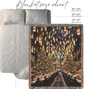 May include: A woven blanket featuring a detailed image of a grand hall with hanging lanterns and Christmas trees, displayed on a bed with white bedding. The blanket size chart shows dimensions of 203 x 152 cm, 152 x 127 cm, and 132 x 193 cm.