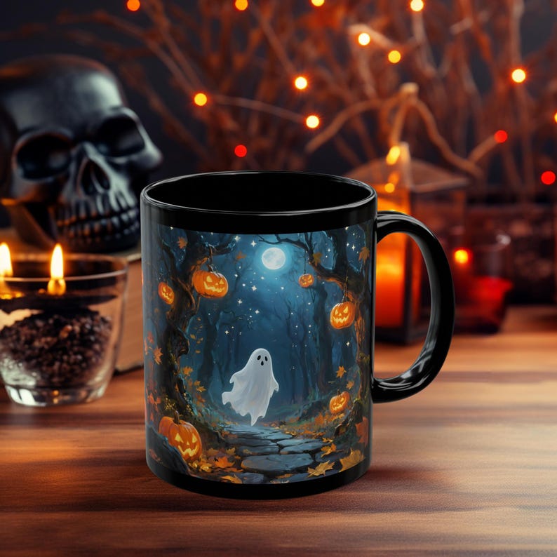 May include: Black ceramic mug with a Halloween-themed design. The artwork features a spooky forest scene with a ghost, pumpkins, and a full moon. The mug has a black handle and interior, perfect for seasonal beverages.