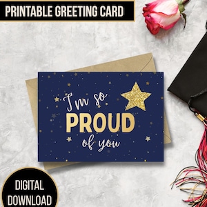 May include: A navy blue greeting card with gold text reading "I'm so PROUD of you" and a gold glitter star. The card is on a brown envelope. The words "PRINTABLE GREETING CARD" and "DIGITAL DOWNLOAD" are also visible.
