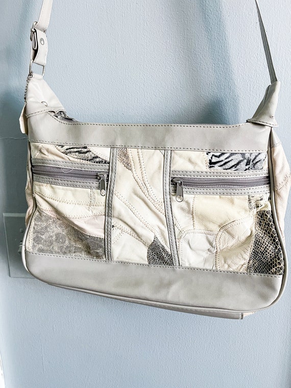 white and gray leather purse