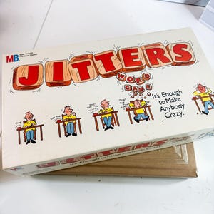 May include: A vintage board game box with the title "JITTERS" in large red letters on a white background. The box features a cartoon illustration of people playing the game, with the text "It's Enough to Make Anybody Crazy."