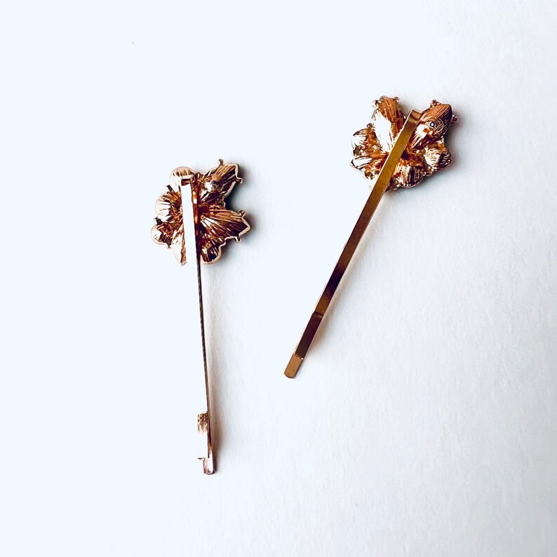 a set of 2 vintage inspired emerald green with rhinestone jewel accents and gold base bobby pin set. Special occasion, gift idea, hair jewelry.