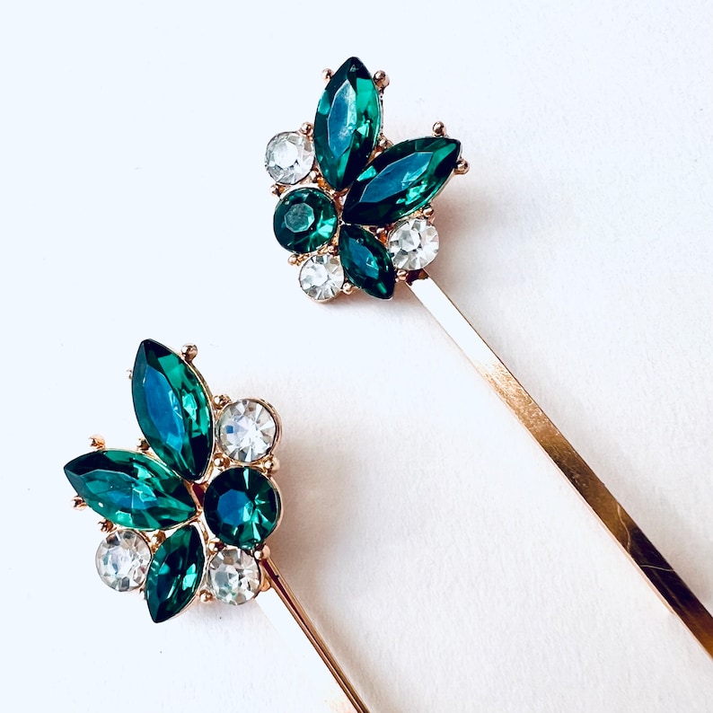 a set of 2 vintage inspired emerald green with rhinestone jewel accents and gold base bobby pin set. Special occasion, gift idea, hair jewelry.