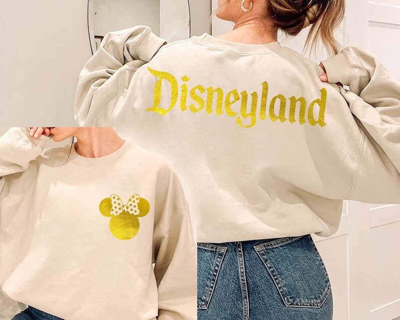 Sand Disneyland Sweatshirt With Gold Letter featuring a Minnie Mouse design on the front and Disneyland text on the back, perfect for Disney fans. This cozy Disney Crewneck is great for trips or casual wear.