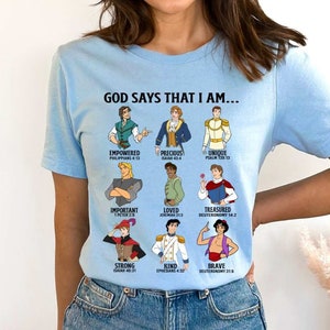 May include: Light blue t-shirt with the text "GOD SAYS THAT I AM..." and illustrations of cartoon princes with words like "Empowered," "Precious," and "Unique." The shirt also includes Bible verses.