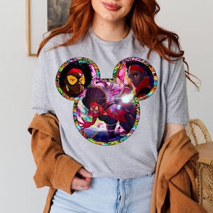 a woman with red hair wearing a mickey mouse shirt