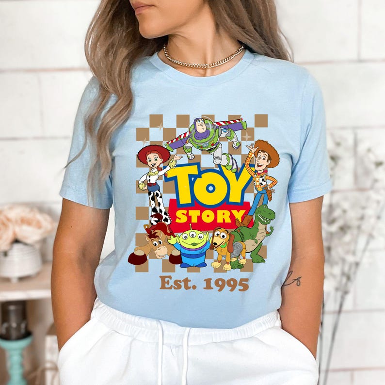 a woman wearing a blue toy story t - shirt