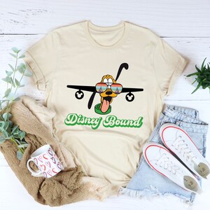 a t - shirt that says disney bound with a plane on it