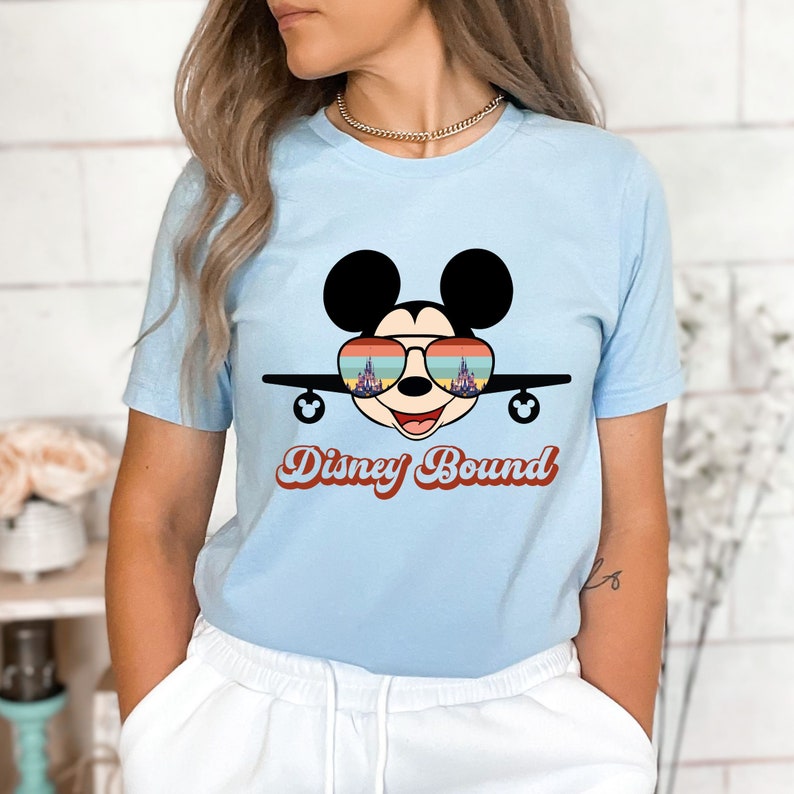 a woman wearing a mickey mouse t - shirt