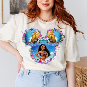 a woman with red hair wearing a mickey mouse t - shirt