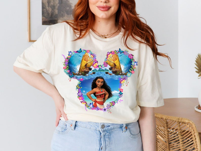 a woman with red hair wearing a mickey mouse t - shirt
