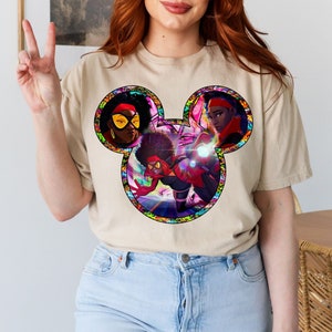 a woman with red hair wearing a mickey mouse t - shirt
