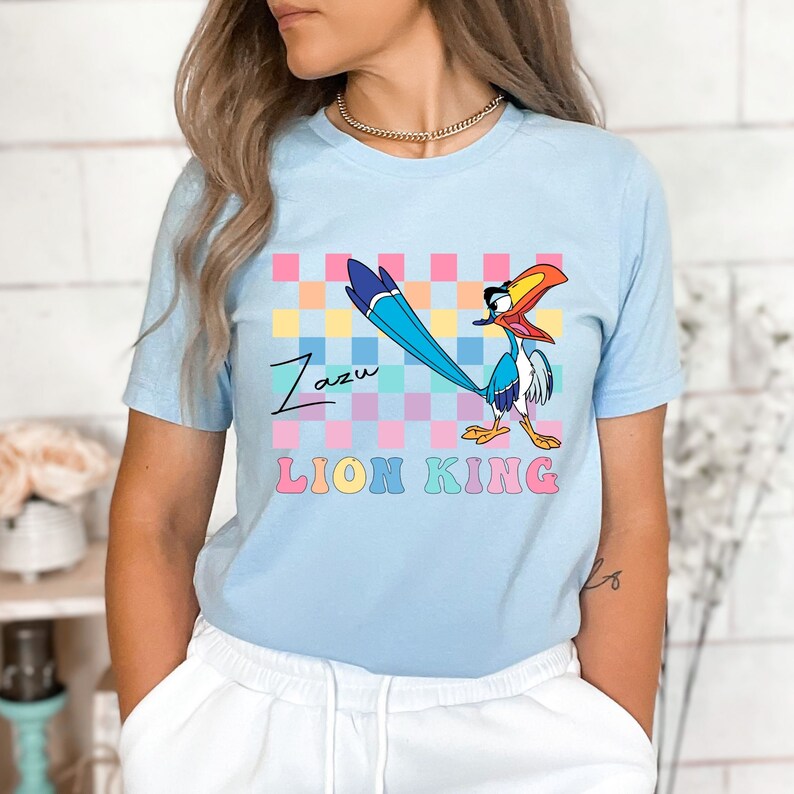 a woman wearing a blue shirt with a bird on it