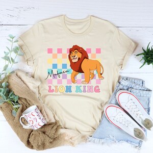 a t - shirt with a lion on it next to a pair of jeans