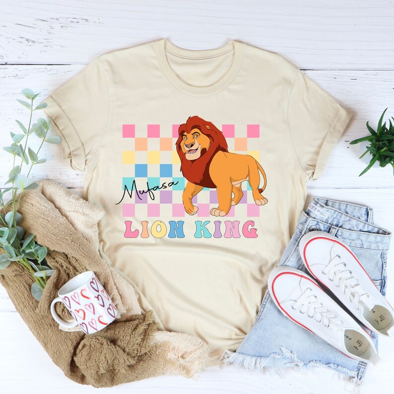 a t - shirt with a lion on it next to a pair of jeans