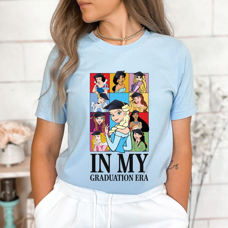 a woman wearing a blue shirt with cartoon characters on it