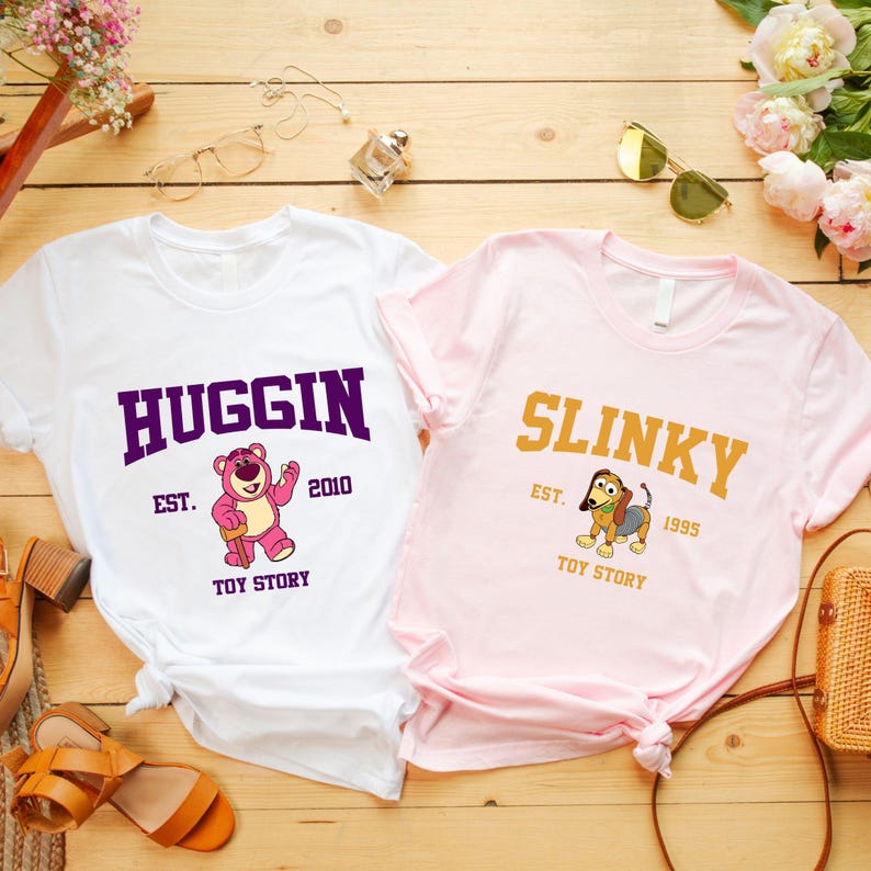 a pair of pink and white shirts sitting on top of a wooden table